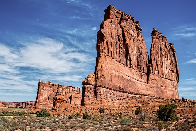 Large red rock monoliths and sandstone towers in a desert landscape