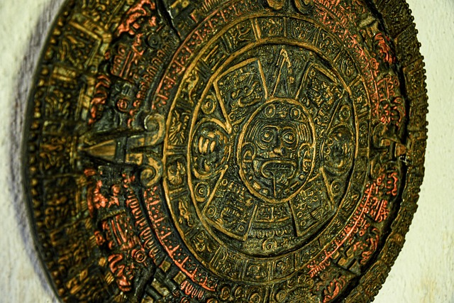 A carved Aztec calendar stone mounted on a wall