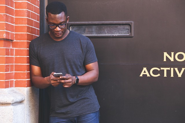 A man looking at his smartphone outdoors