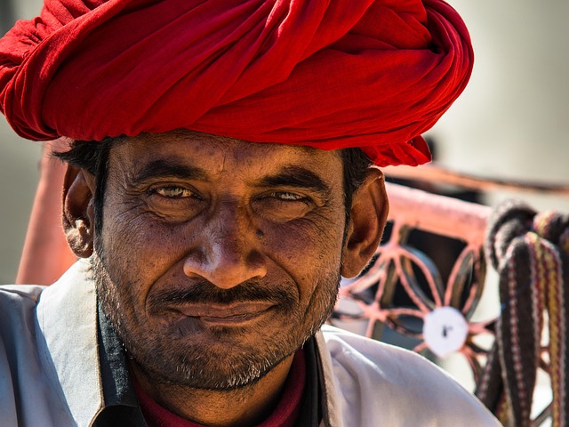 Close-up portrait of an Indian man wearing a red turban