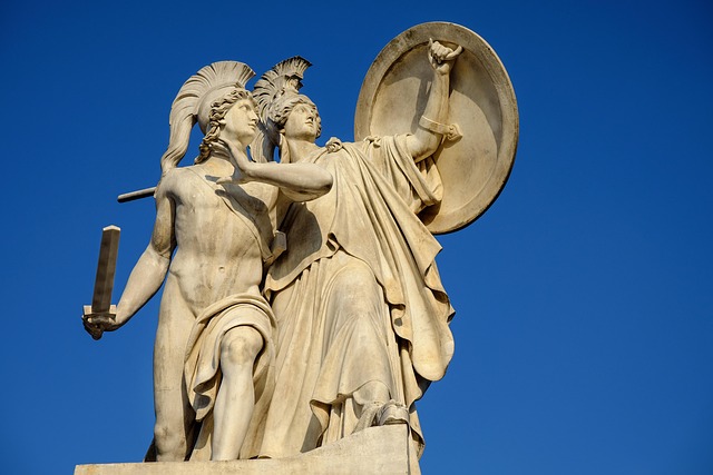 Marble statue of Roman or Greek deities against a blue sky
