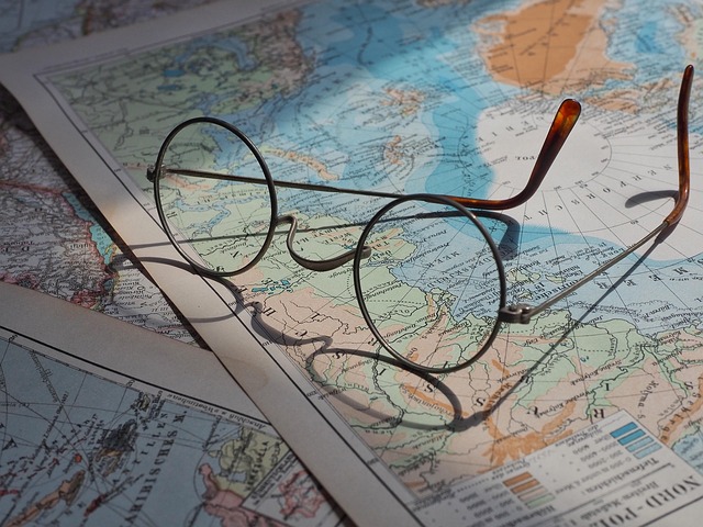 Round eyeglasses lying on top of a world map