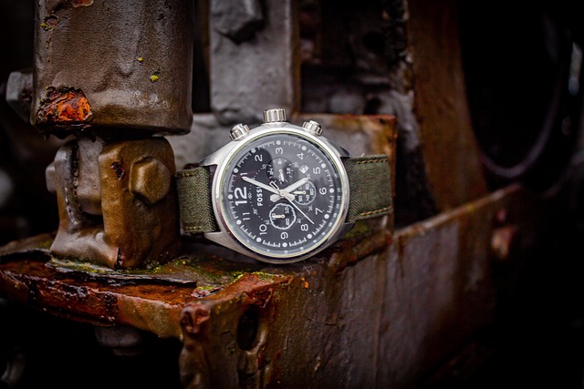 A Fossil wristwatch resting on a rusty metal structure