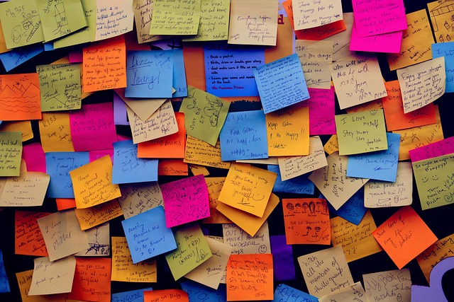 A wall covered in colorful handwritten sticky notes