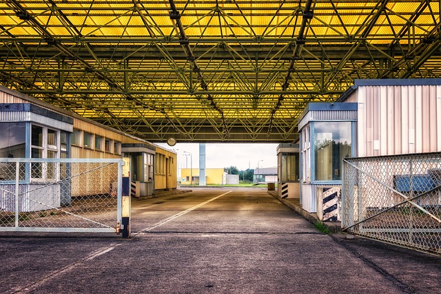 A border checkpoint facility with guard booths under a canopy