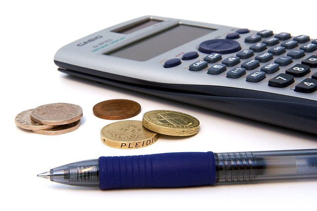 A scientific calculator, coins, and a pen