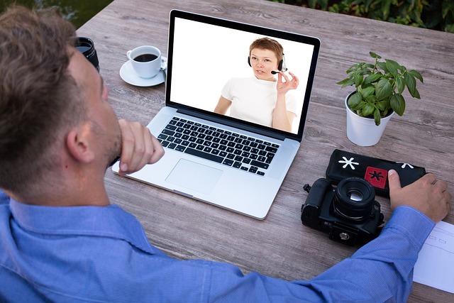 A man having a video call meeting on his laptop