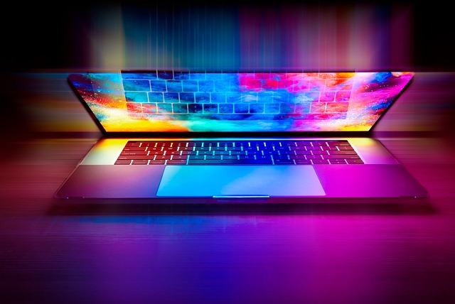 An open laptop illuminated with vibrant colorful lights