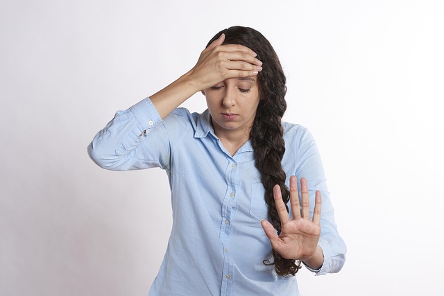 A woman holding her head in frustration and stress
